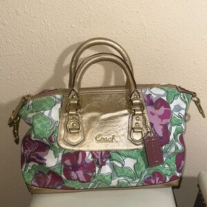 This is a Coach Ashley Floral IRIS Canvas and Metallic Gold Leather Satchel